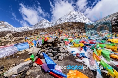 Prayer Flags On Snow Mountains At Yading Stock Photo