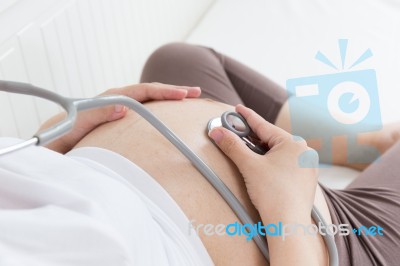 Pregnant Belly With Stethoscope Stock Photo