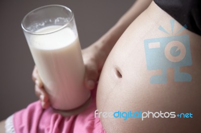 Pregnant Lady Drinking Milk Stock Photo