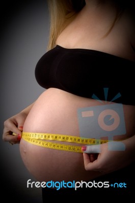 Pregnant Lady Measuring Her Tummy Stock Photo