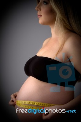 Pregnant Lady Measuring Her Tummy Stock Photo