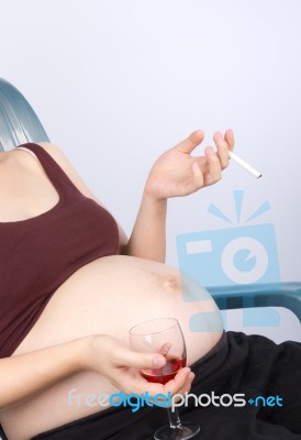 Pregnant Lady with wine cigarette Stock Photo