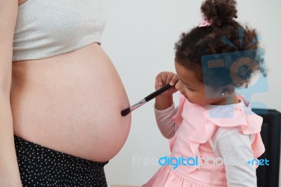 Pregnant Woman And Her Daughter Stock Photo