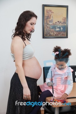 Pregnant Woman And Her Daughter Stock Photo