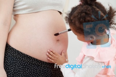 Pregnant Woman And Her Daughter Stock Photo