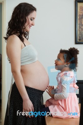 Pregnant Woman And Her Daughter Stock Photo