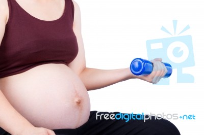 Pregnant Woman Exercising With Dumbbell Stock Photo