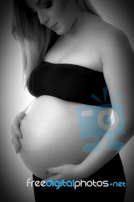 Pregnant Woman Holding Her Tummy Stock Photo