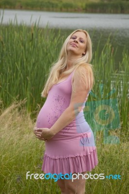 Pregnant Woman Relaxing By The Lake Stock Photo