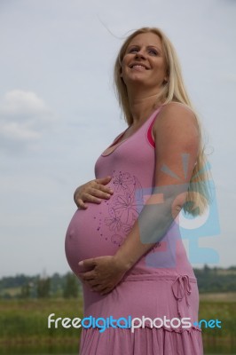 Pregnant Woman Relaxing Outdoors Stock Photo