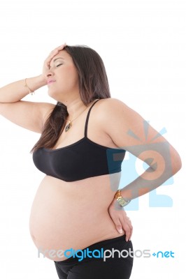 Pregnant Woman Standing With Headache Stock Photo