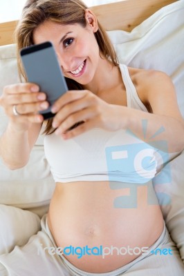 Pregnant Woman Taking A Self-portrait With Her Smartphone Stock Photo