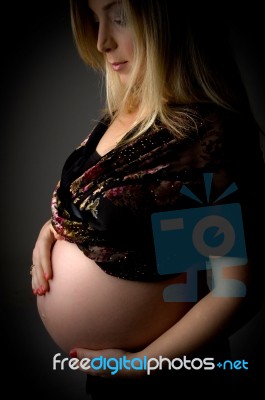 Pregnant Woman Touching Her Tummy Stock Photo