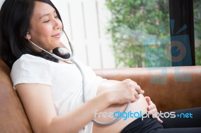 Pregnant Woman Using Stethoscope Stock Photo