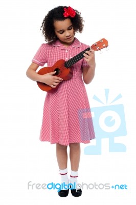 Preschool Cute Girl Playing A Guitar Stock Photo