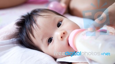 Pretty Baby Girl Is Drinking Milk Stock Photo