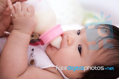 Pretty Baby Girl Is Drinking Milk Stock Photo