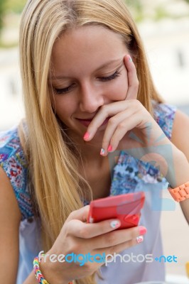 Pretty Blonde Young Woman Chatting With The Smartphone Stock Photo