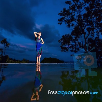 Pretty Brunette Model In Beach Dress Posing At The Pool Stock Photo