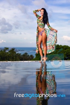 Pretty Brunette Model In Bikini Posing At The Pool Stock Photo