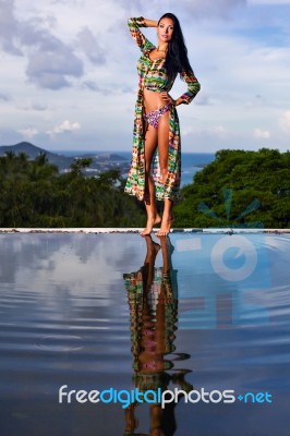 Pretty Brunette Model In Bikini Posing At The Pool Stock Photo