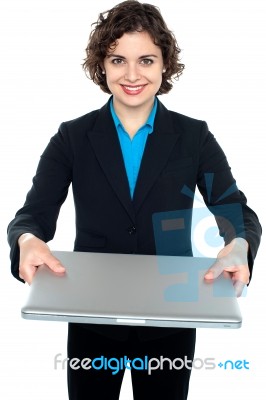 Pretty Businesswoman Presenting A Laptop Stock Photo