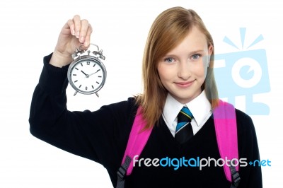 Pretty Charming Schoolgirl Holding Time Piece Stock Photo