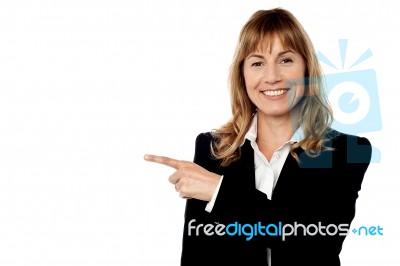 Pretty Corporate Lady Pointing Away Stock Photo