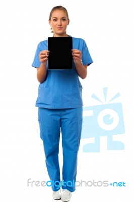 Pretty Doctor Showcasing A Portable Tablet Stock Photo