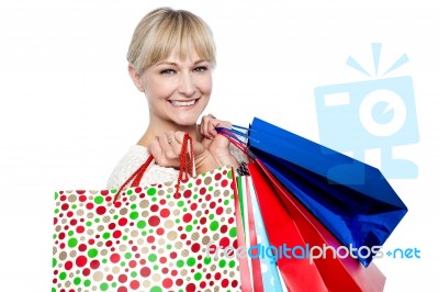 Pretty Female Carrying Shopping Bags Over Shoulders Stock Photo