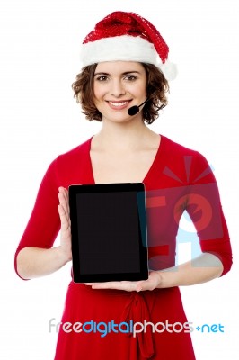 Pretty Female Santa Presenting Touch Pad Stock Photo