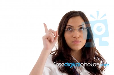 Pretty Female Wearing Spectacles Pointing Upwards Stock Photo