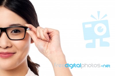 Pretty Girl Adjusting Her Spectacles Stock Photo