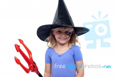 Pretty Girl In Witches Hat Holding Devils Pitchfork Stock Photo