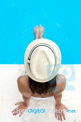 Pretty Girl Relaxing At The Swimming Pool In The Summertime Stock Photo