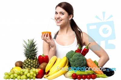 Pretty Girl Sipping Orange Juice With A Straw Stock Photo