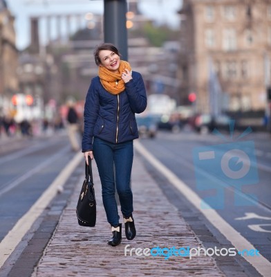 Pretty Girl Walking On The Road Stock Photo