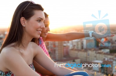 Pretty Girls Looking At The Views In The City Stock Photo