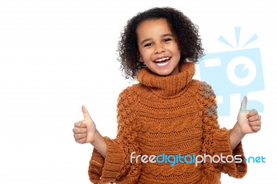 Pretty Kid Laughing And Showing Double Thumbs Up Stock Photo