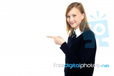 Pretty Schoolgirl Pointing Towards Copy Space Area Stock Photo