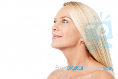 Pretty Smiling Woman Looking Upwards Stock Photo