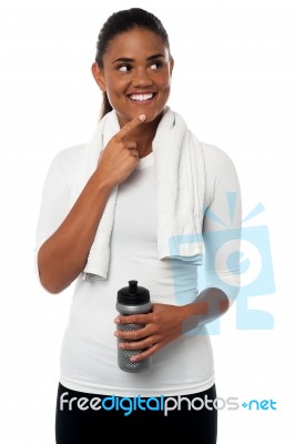 Pretty Sportswoman Thinking And Smiling Stock Photo