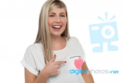 Pretty Teen Pointing Towards Pink Paper Heart Stock Photo