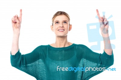 Pretty Teen Pointing Upwards Stock Photo