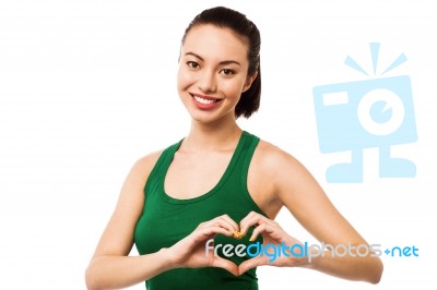 Pretty Teenager Making Heart Symbol With Hands Stock Photo