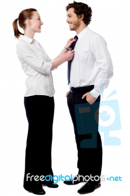 Pretty Woman Adjusting Her Husband's Tie Stock Photo