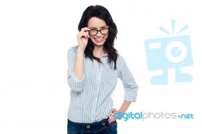 Pretty Woman Adjusting Her Spectacles Stock Photo