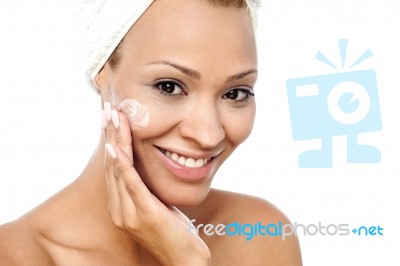 Pretty Woman Applying Face Cream Stock Photo