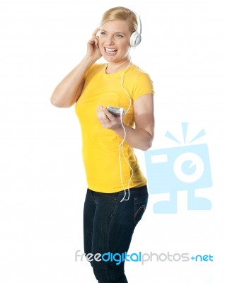 Pretty Woman Holding Music Player Stock Photo