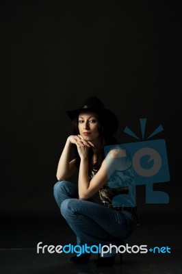 Pretty Woman In Black Hat In Studio Stock Photo